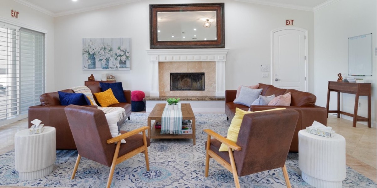 Group lounge with leather sofas, fireplace, and modern decor