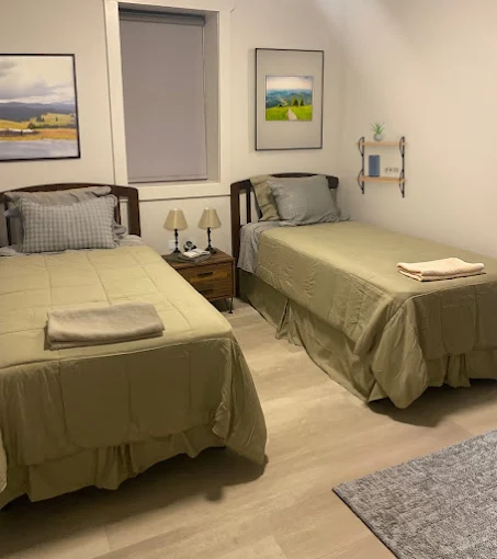 Shared bedroom with two twin beds and nightstand