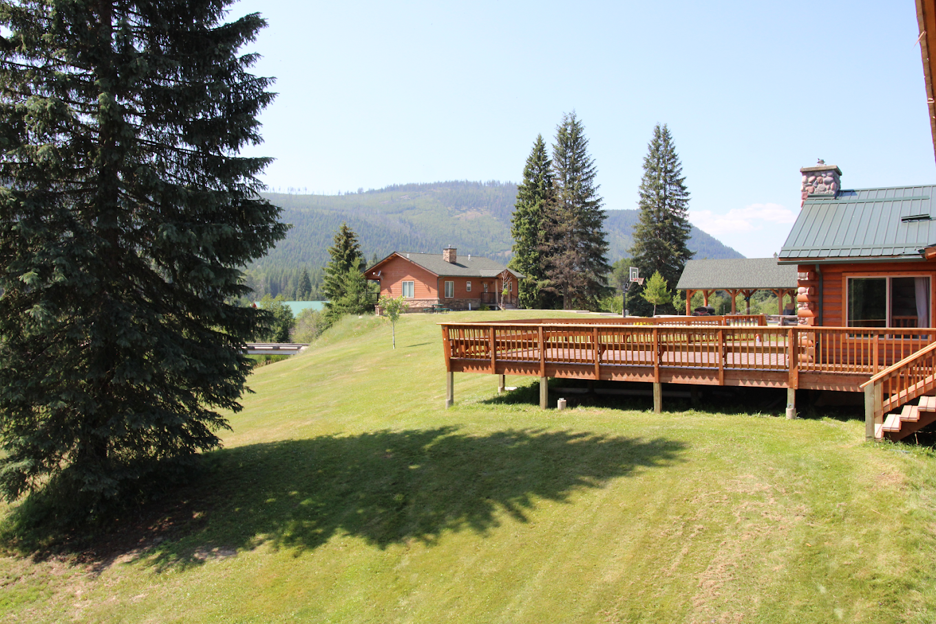 View of multiple cabins with hills and pine trees