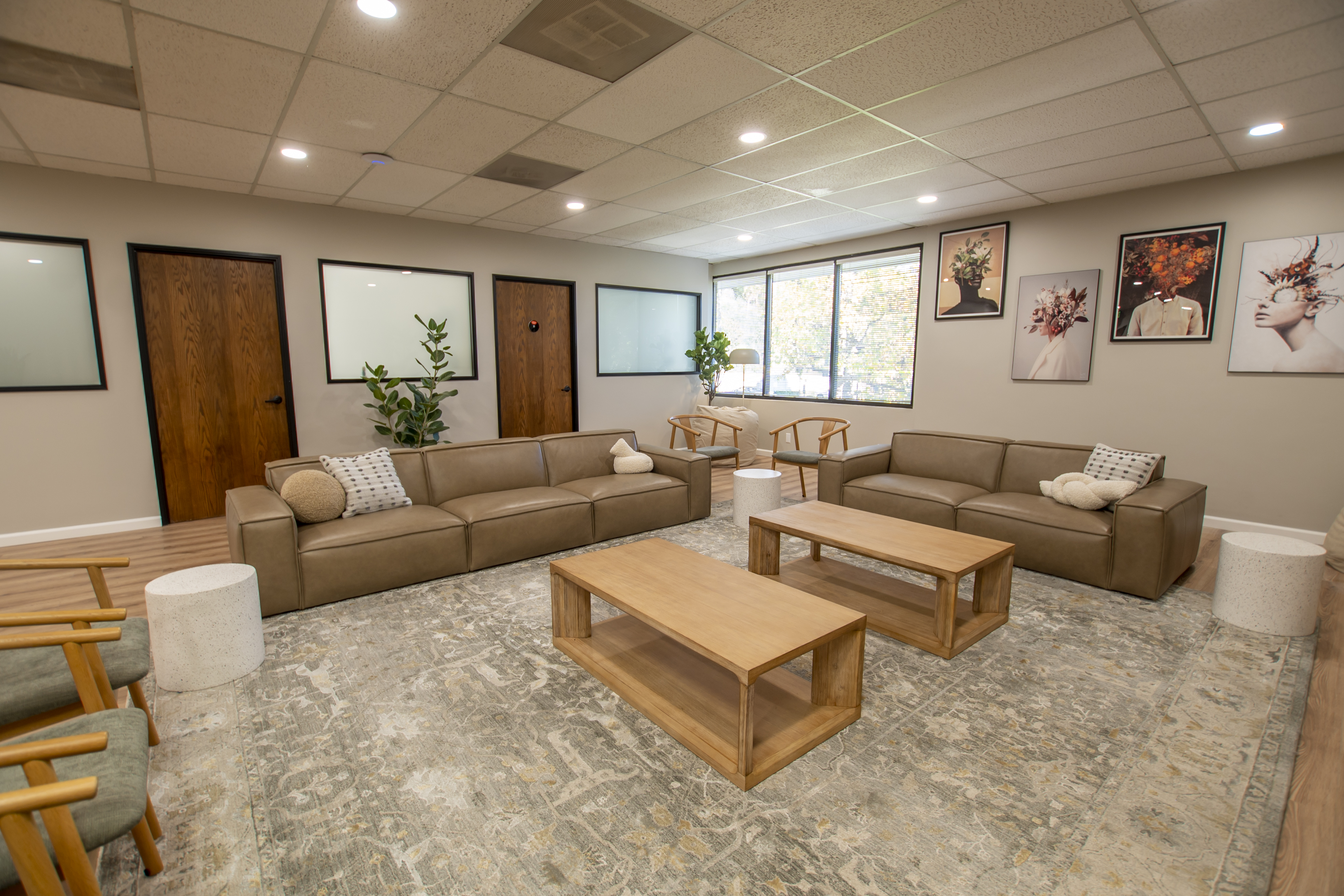 Lounge area with tan sofas and framed wall art