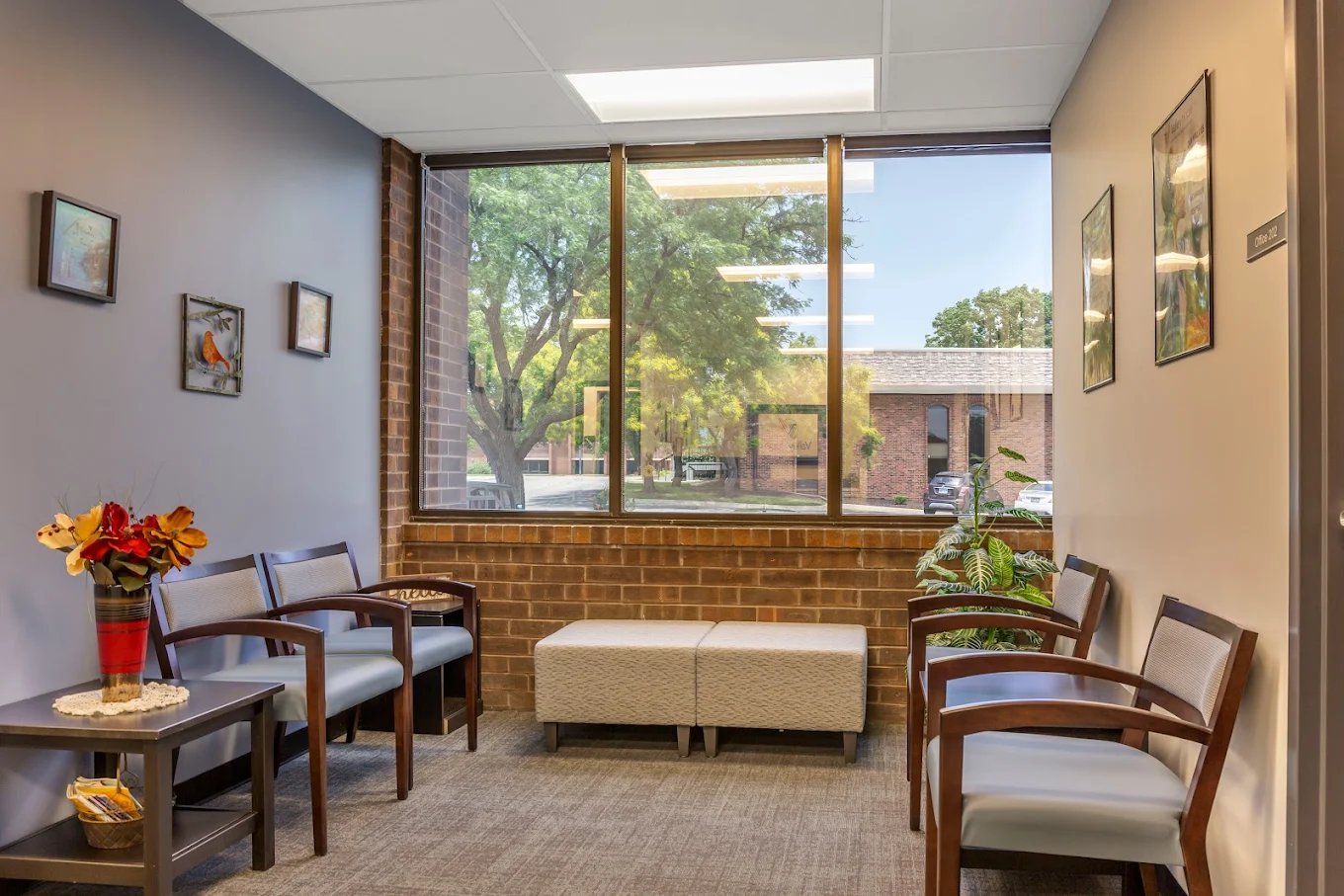 Seating area with chairs, table, and large window view
