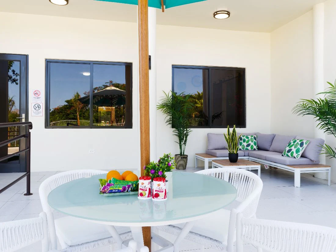 Patio lounge with umbrella table and sofa seating