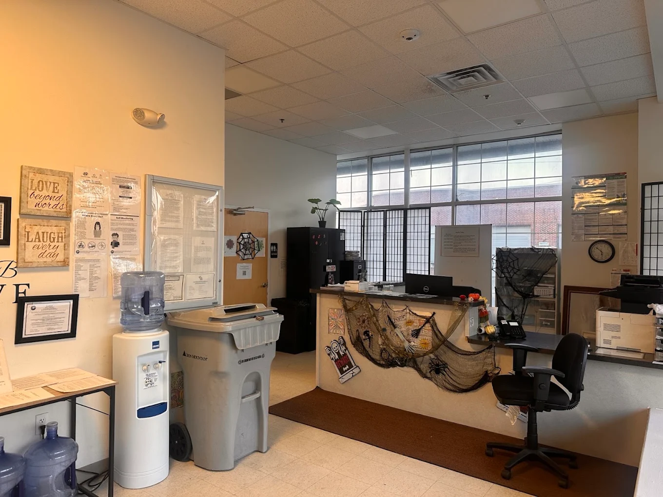 Reception office with front desk, windows, and water cooler