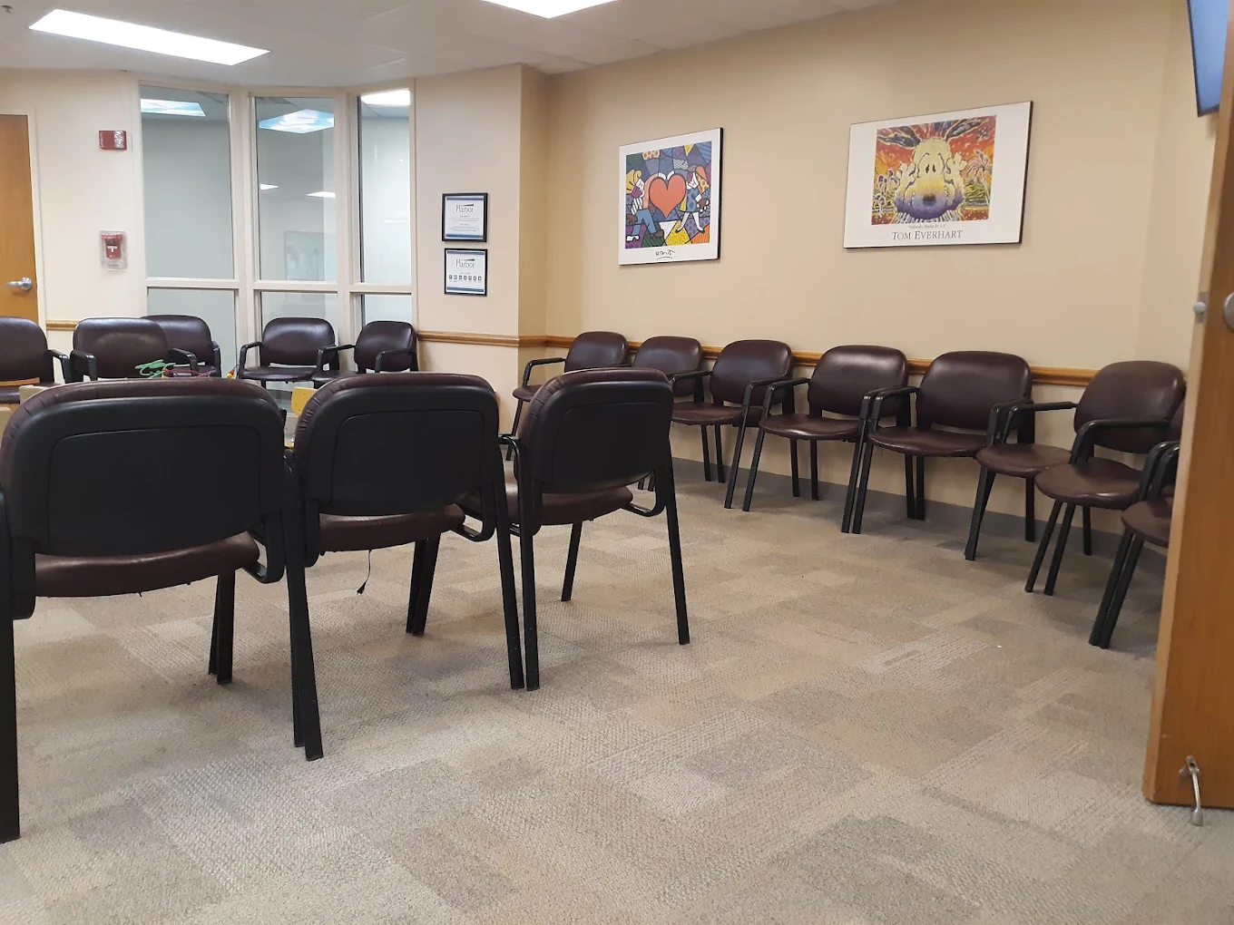 Circle of chairs in meeting room with framed art on walls
