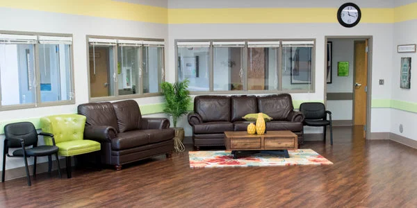 Lounge with leather seating and a colorful rug