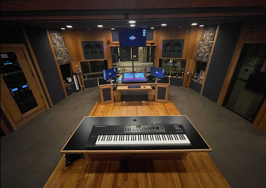Modern music recording studio with piano and sound equipment