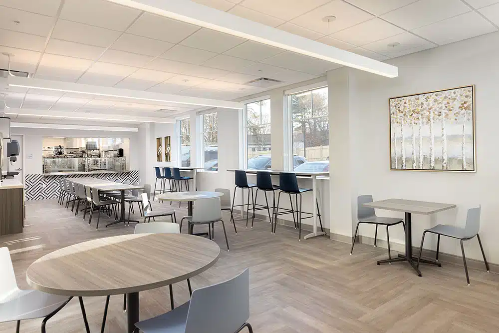 Modern dining area with tables, chairs, and serving counter