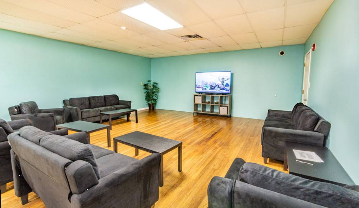 Group lounge with sofas, coffee tables, and television