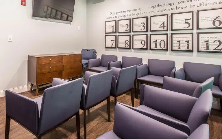 Group therapy room with arranged chairs.