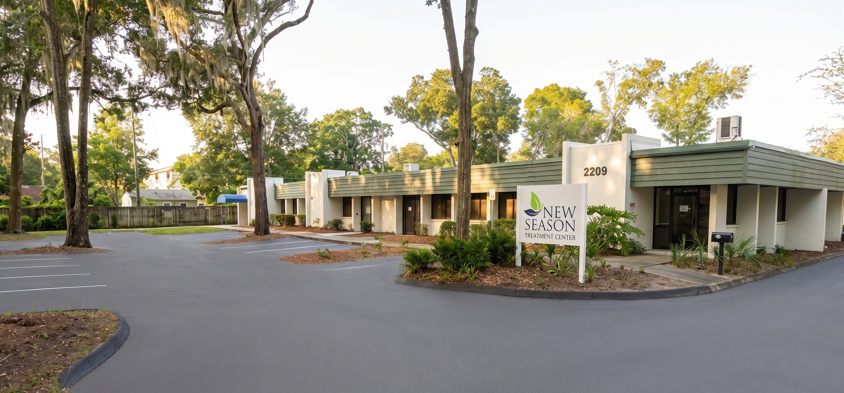 New Season Treatment Center exterior with trees and parking lot