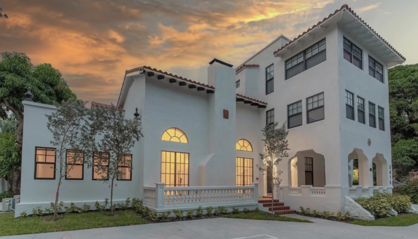Exterior of a white building at sunset.