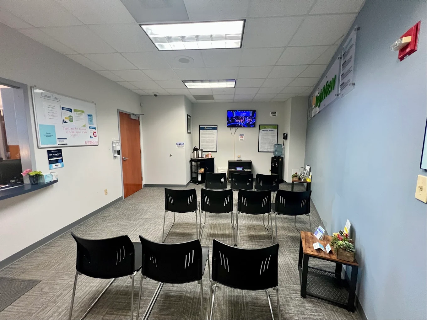 Group room with rows of black chairs and television