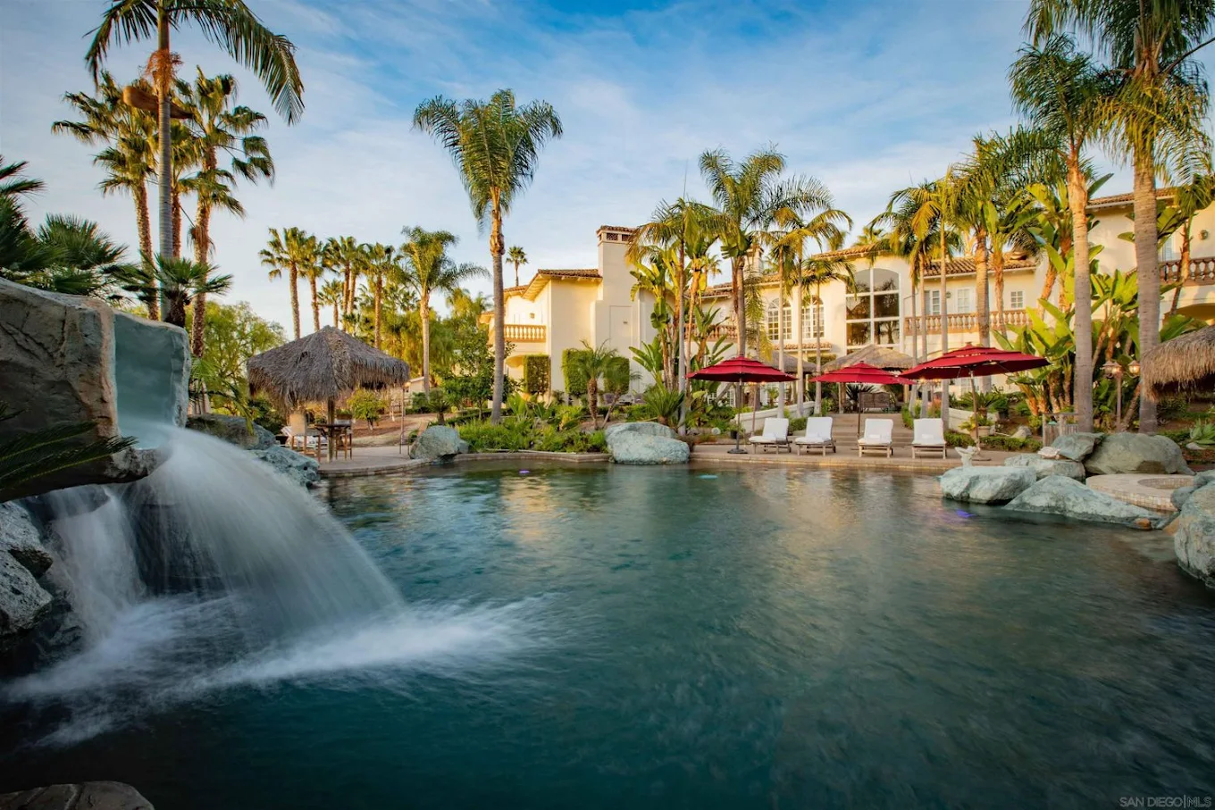 Tropical pool with waterfall and lounge chairs