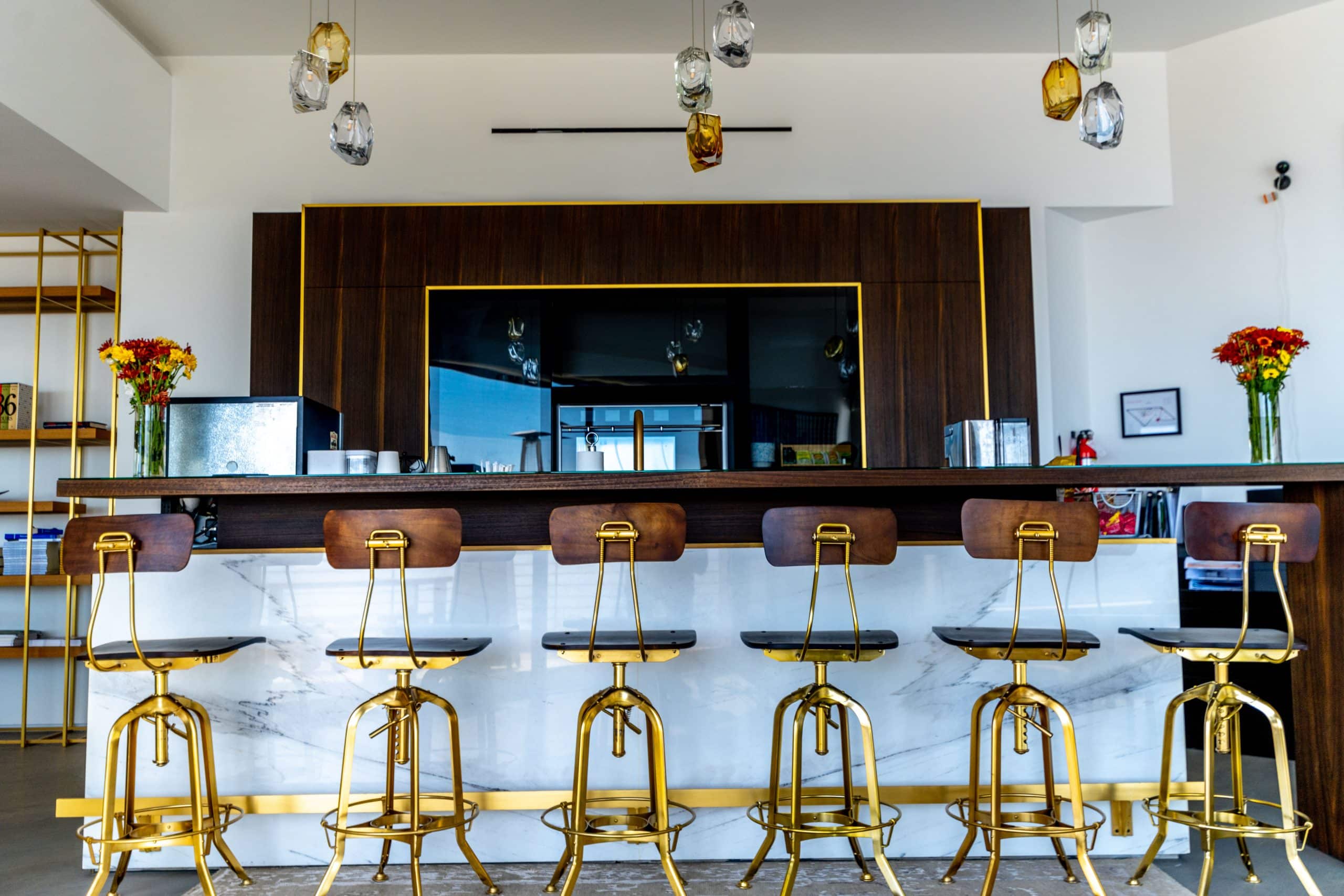 Communal bar area with counter seating and modern lighting