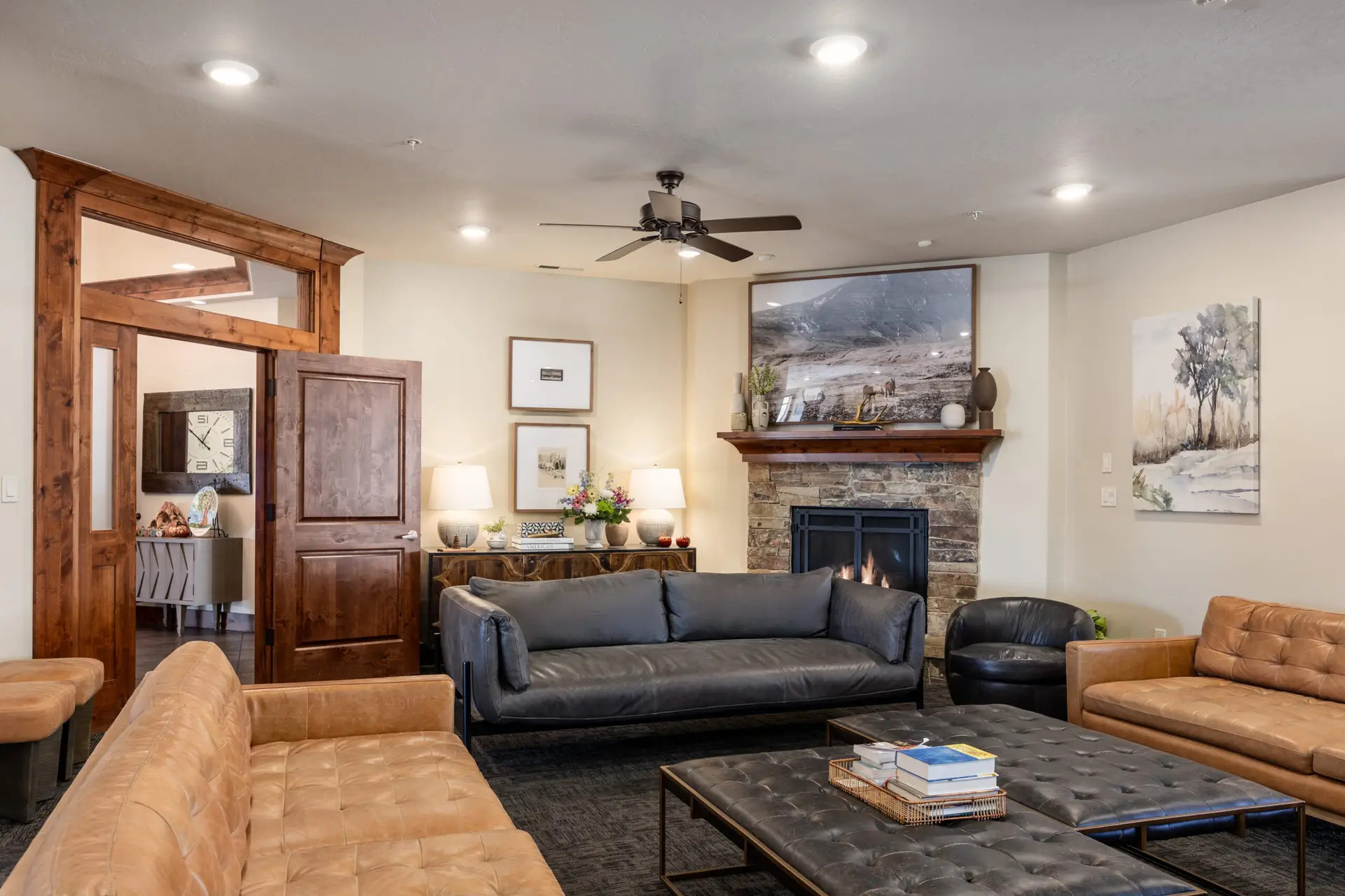 Lounge with leather sofas, fireplace, and decor