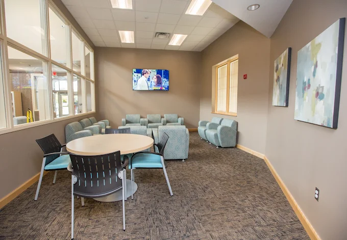 Lounge with couches, chairs, and TV on the wall