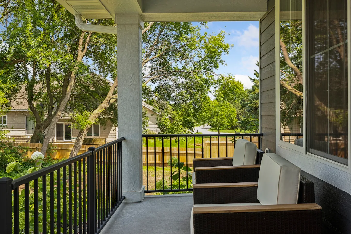 Covered deck with chairs facing garden