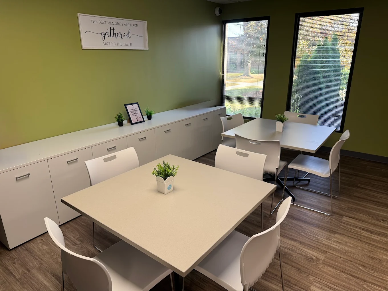 Group room with tables, chairs, cabinets, and large windows