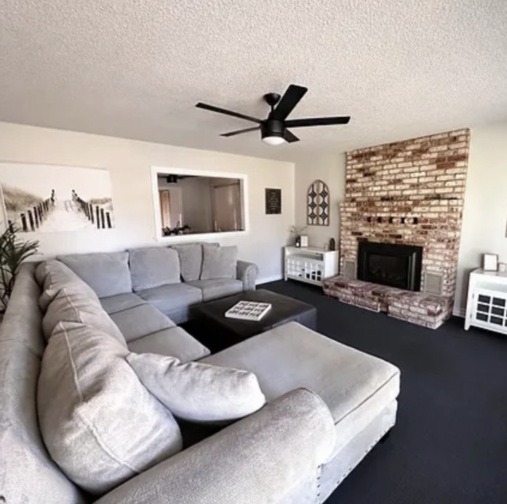 Lounge area with couches in front of firplace.