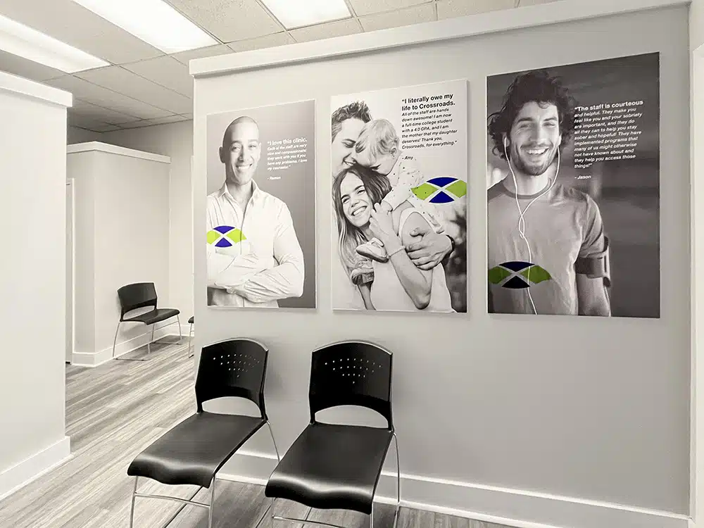 Hallway with black chairs and patient testimonial posters