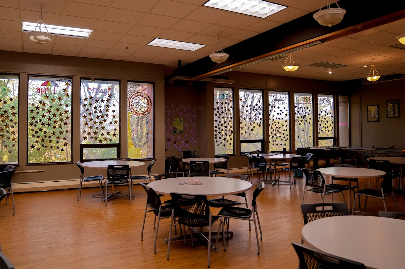 Dining room with tables and natural light at EOSIS Tapestry