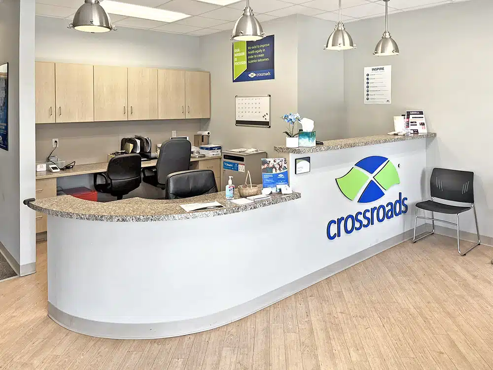 Reception desk with office workspace and overhead lighting