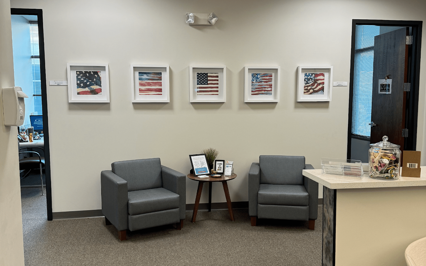 Quiet seating area with two armchairs and framed wall art