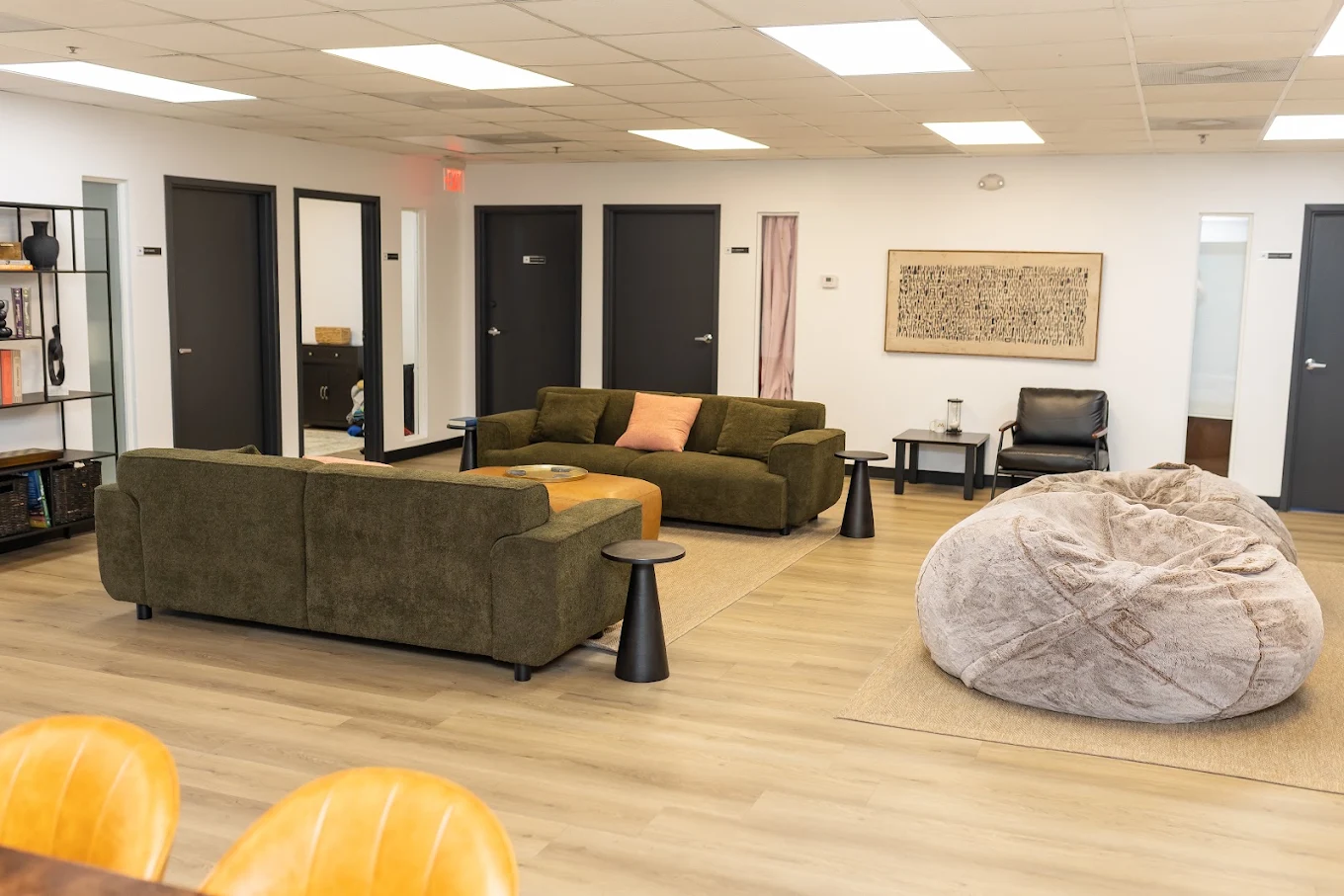 Common area with sofas, chairs, and a large bean bag