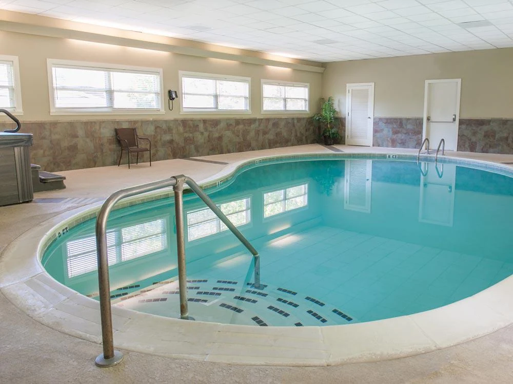 Indoor pool with steps and tiled deck area