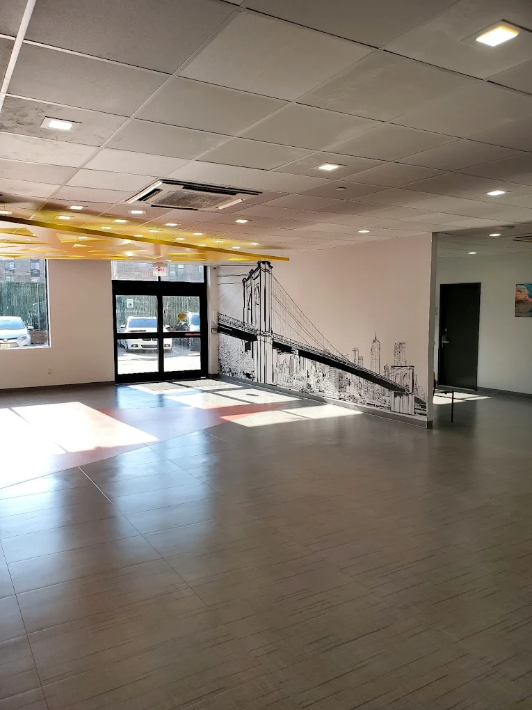 Spacious hall with Brooklyn Bridge mural and bright lighting