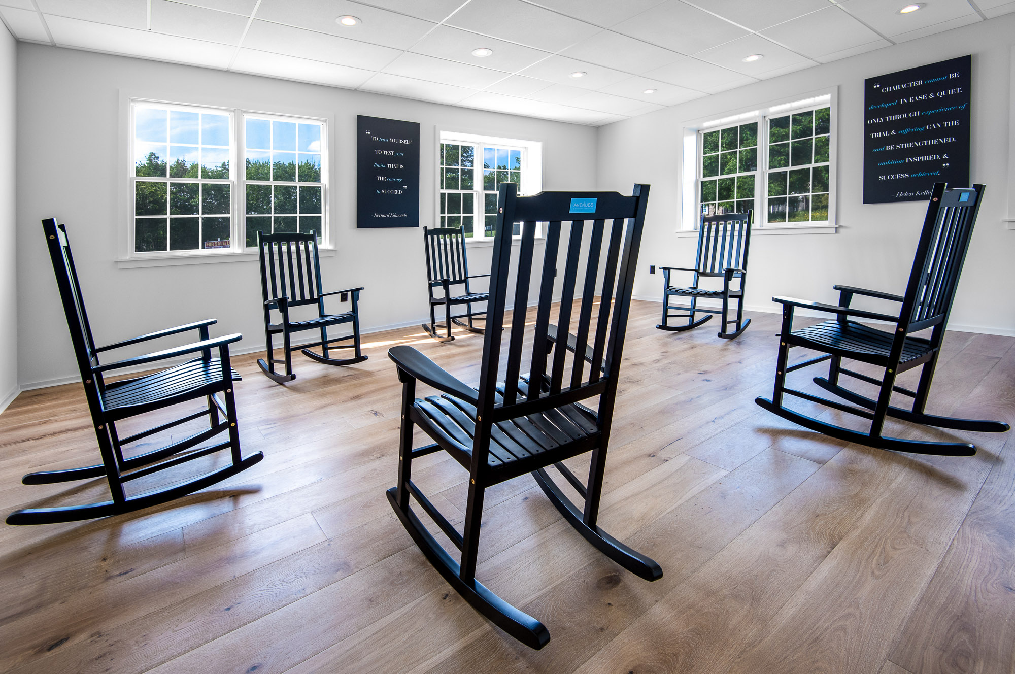 Black rocking chairs in a bright group therapy circle