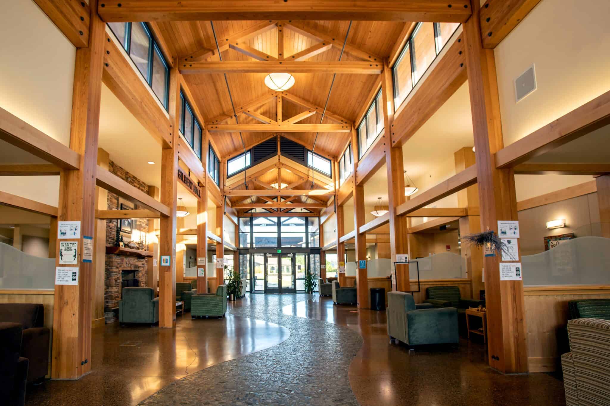 Spacious wood-beamed lobby with natural light and seating