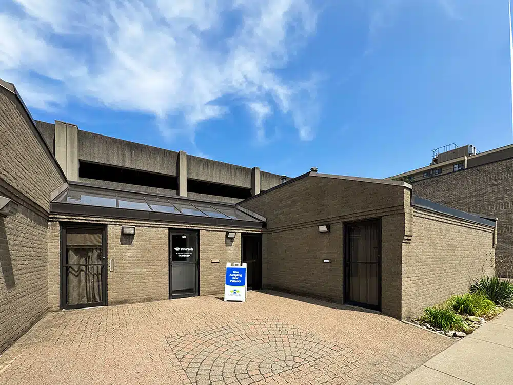 Clinic exterior entrance with sign and brick courtyard