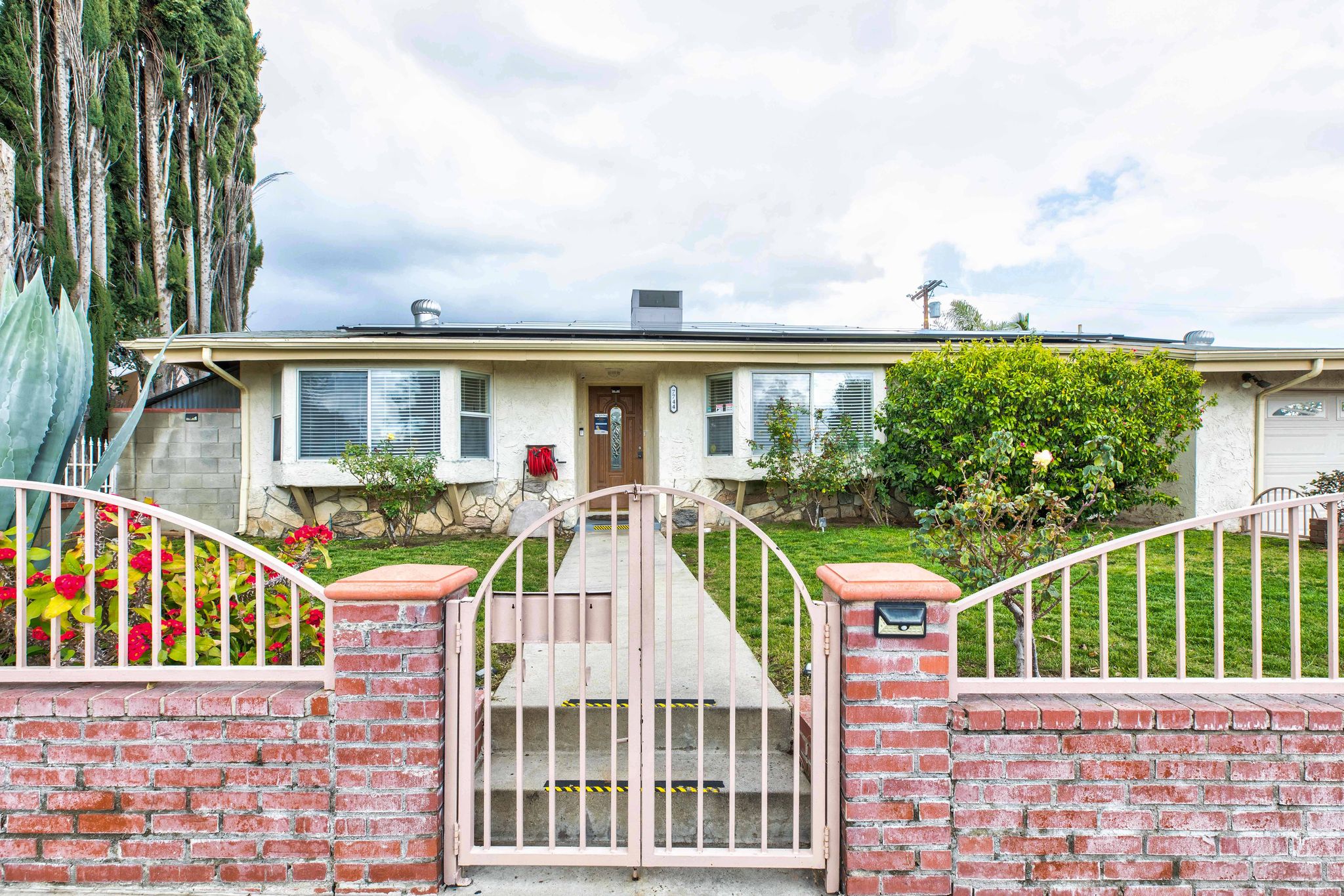 Facility entrance with a lawn and walkway.