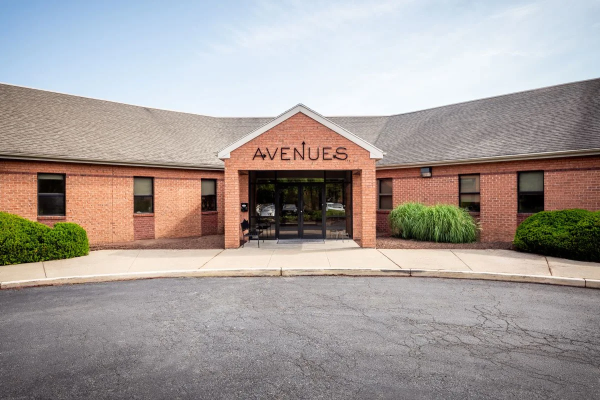 Brick entryway labeled Avenues above the door