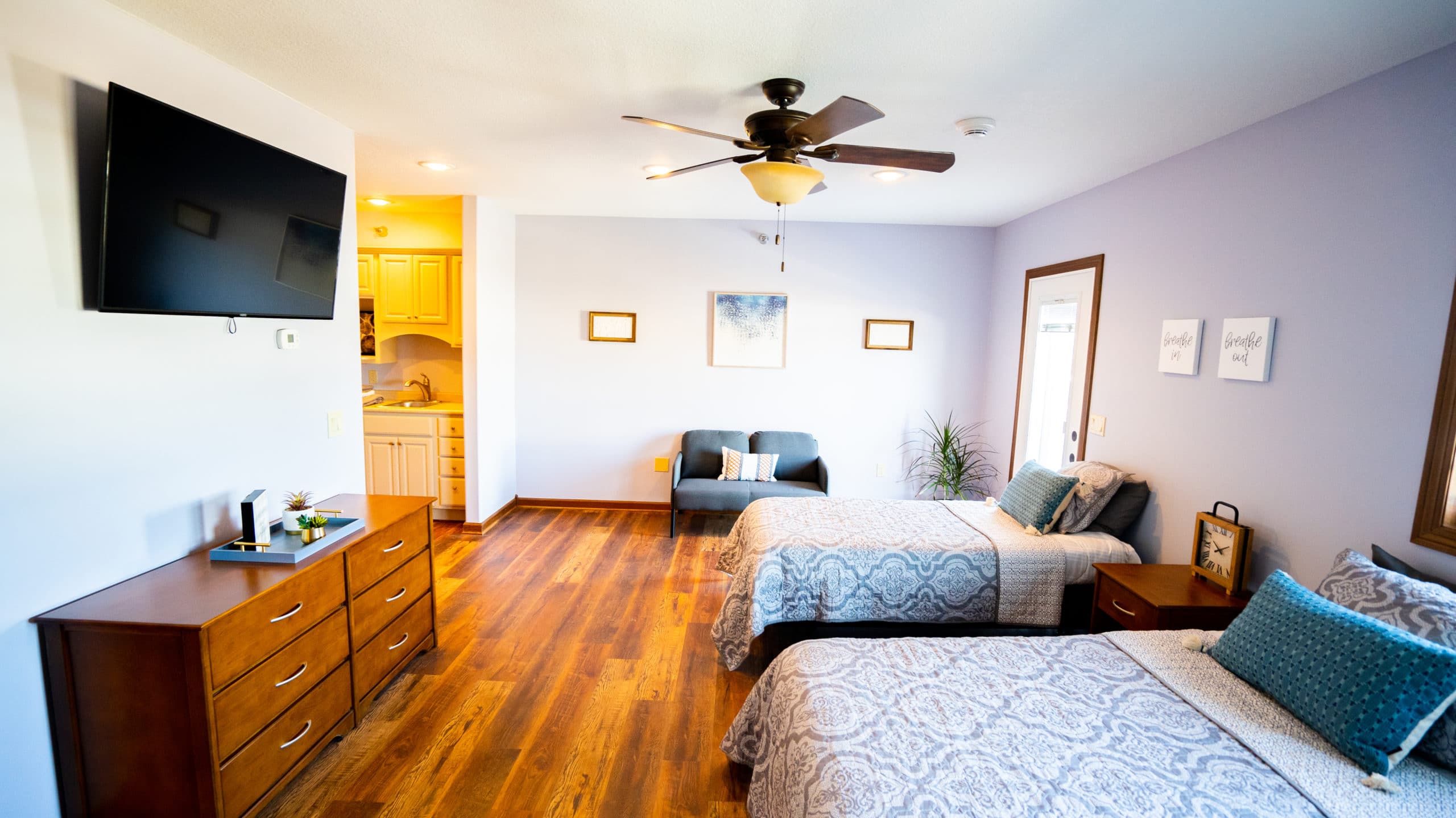 A bright shared bedroom with twin beds and modern decor.