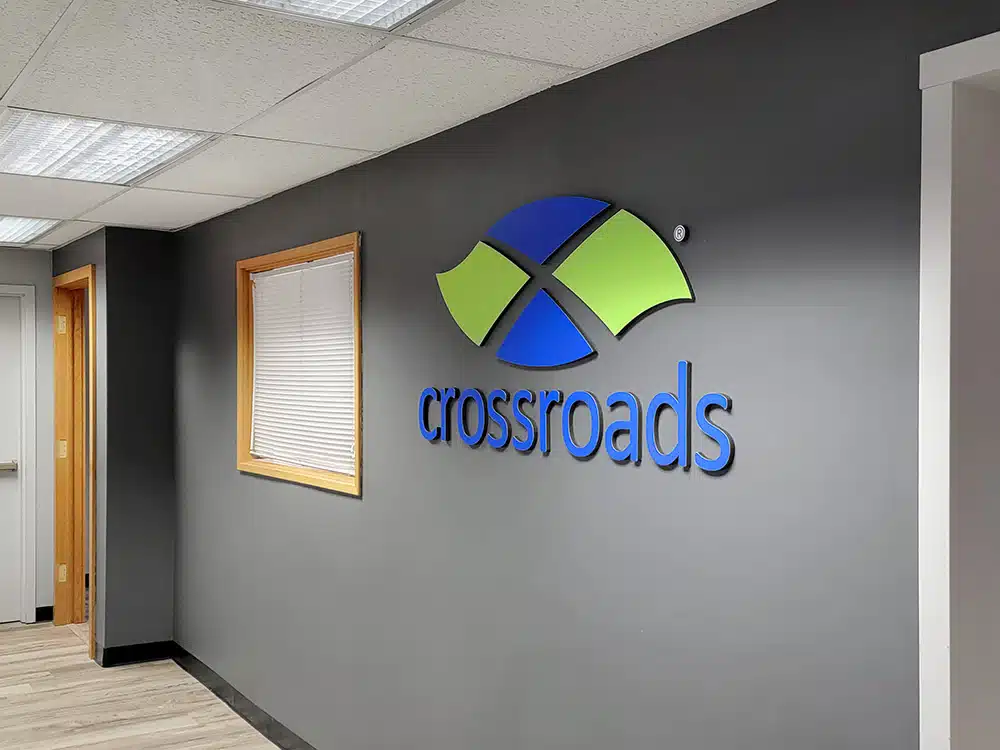 Hallway with Crossroads logo sign on dark gray wall