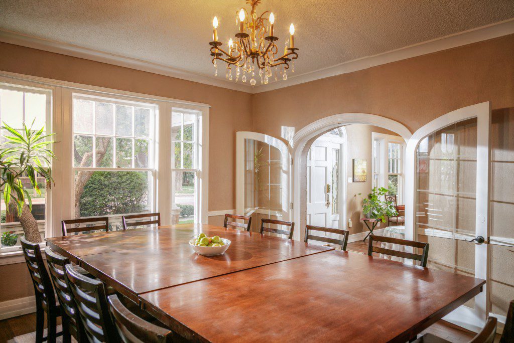 Community dining area with large table and natural light