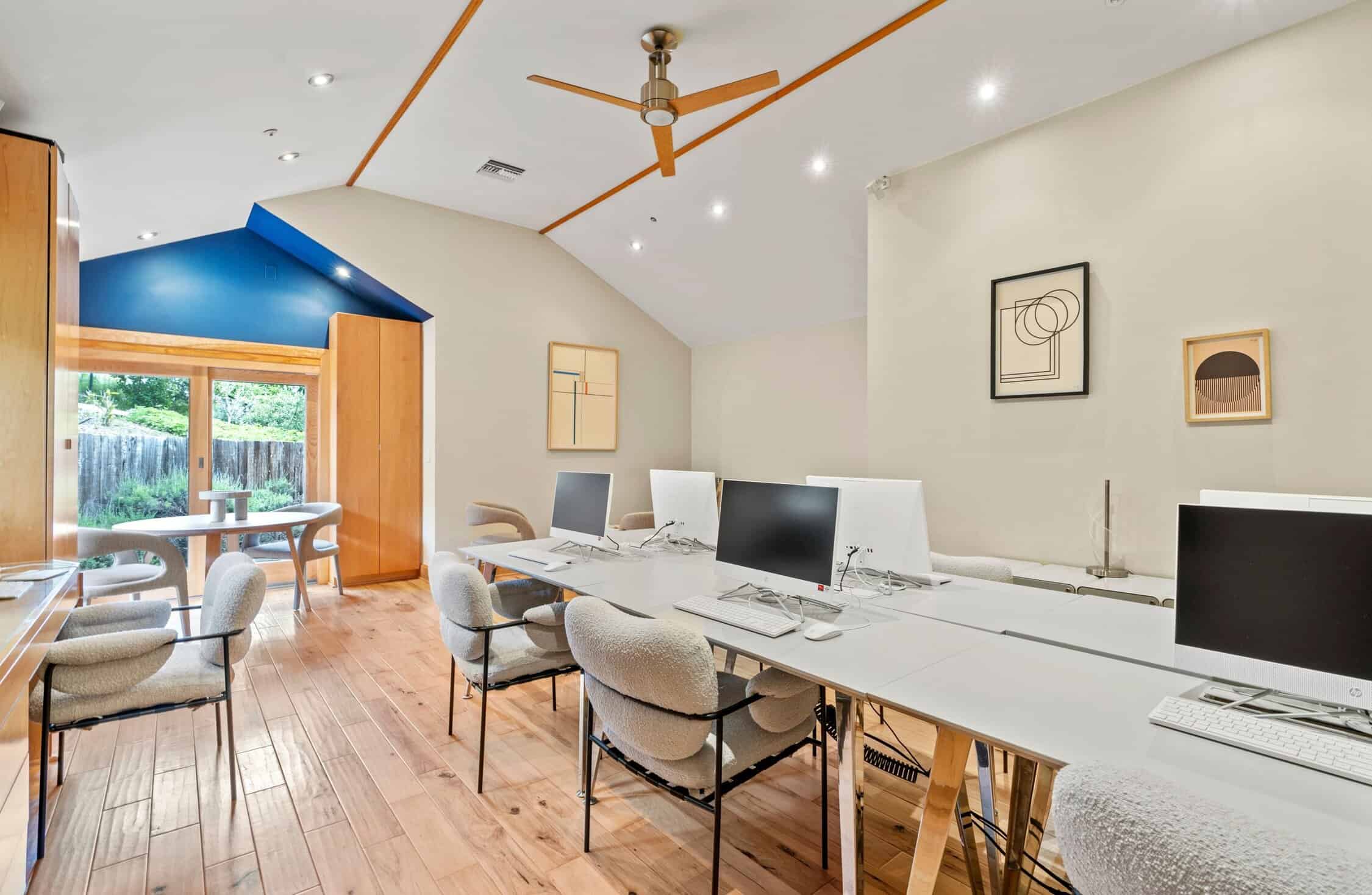 Shared workspace with desktop computers and seating