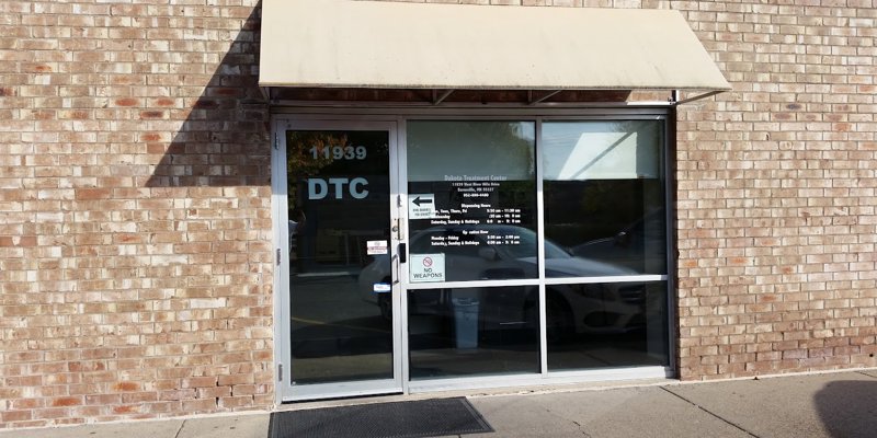 Glass door entrance to Dakota Treatment Center, with clear signage and an awning, providing a welcoming, secure environment for visitors.