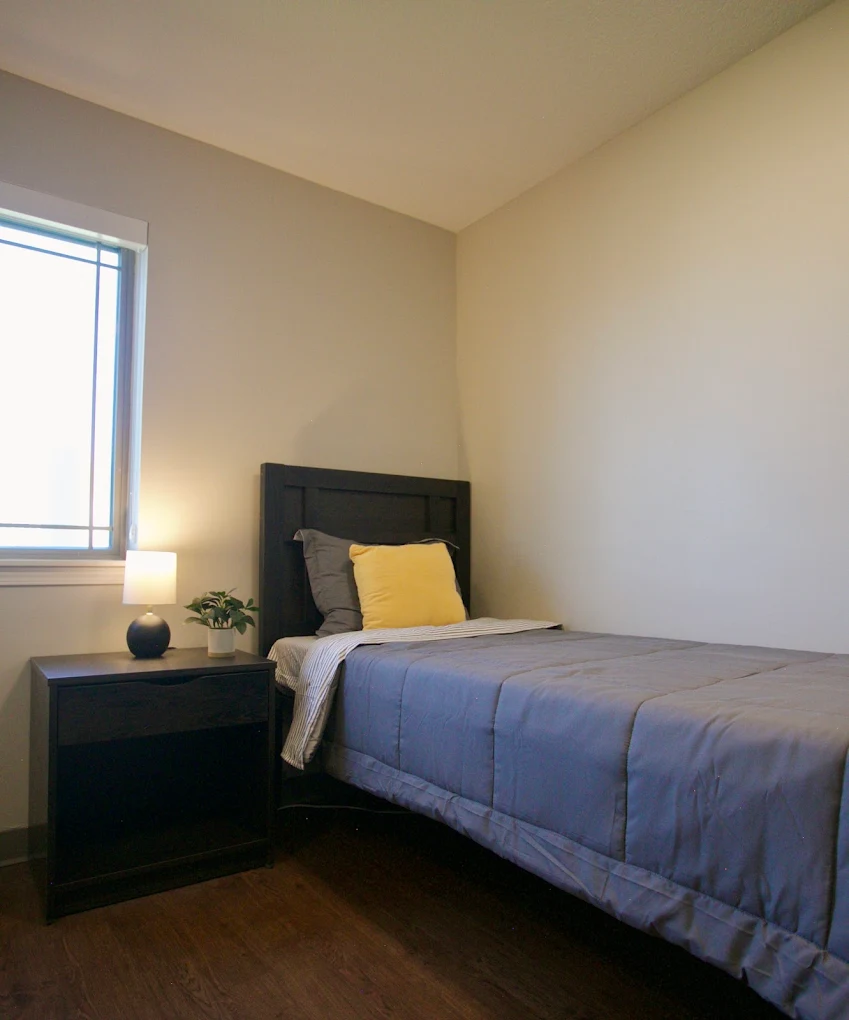 Private client bedroom with single bed and nightstand