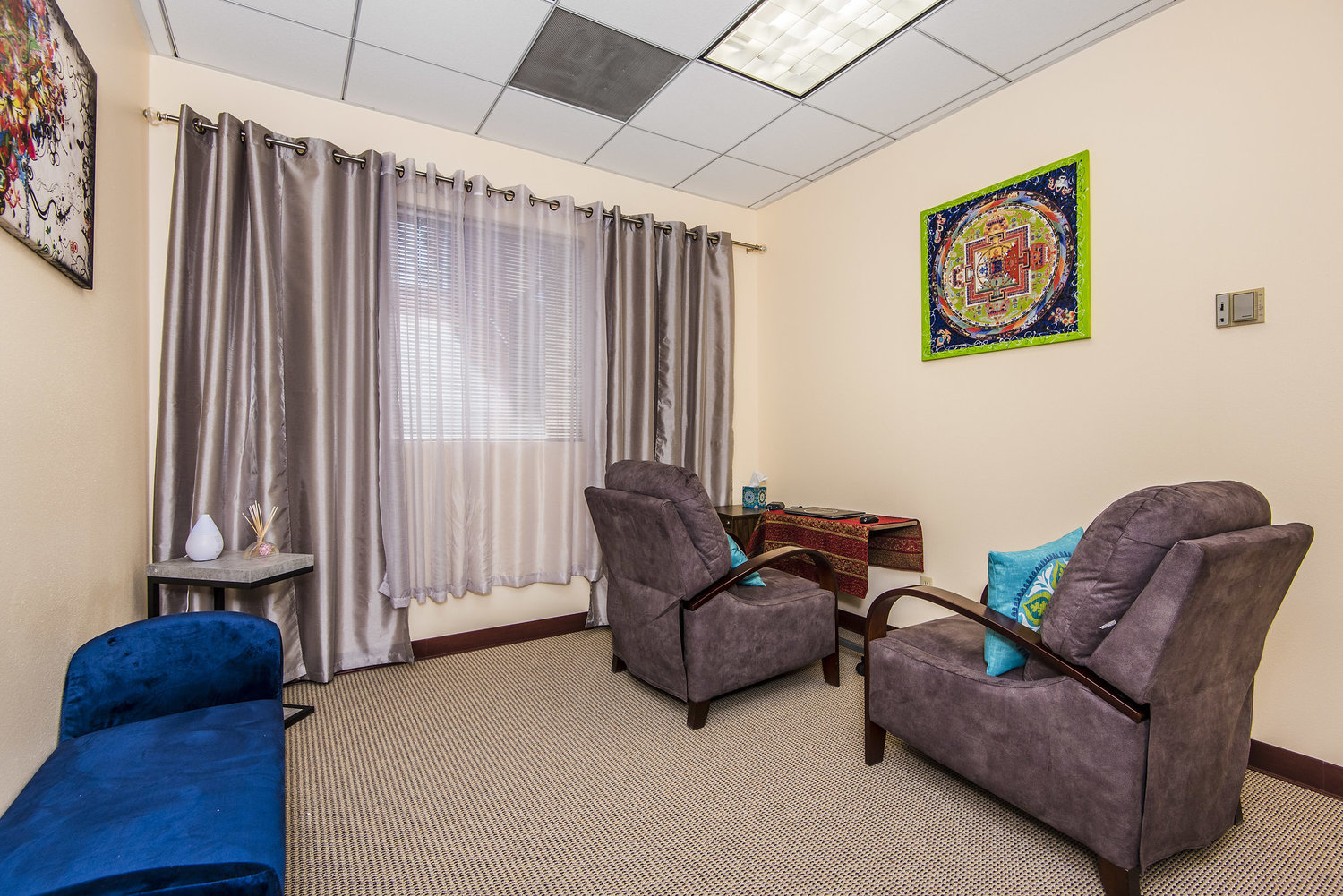 Therapy room with calming lighting and mandala wall art