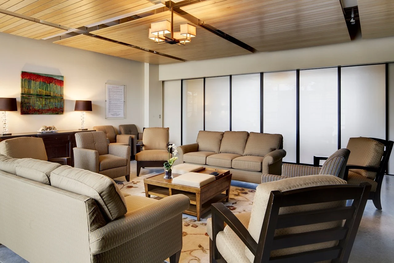 Comfortable group therapy room with chairs and sofas