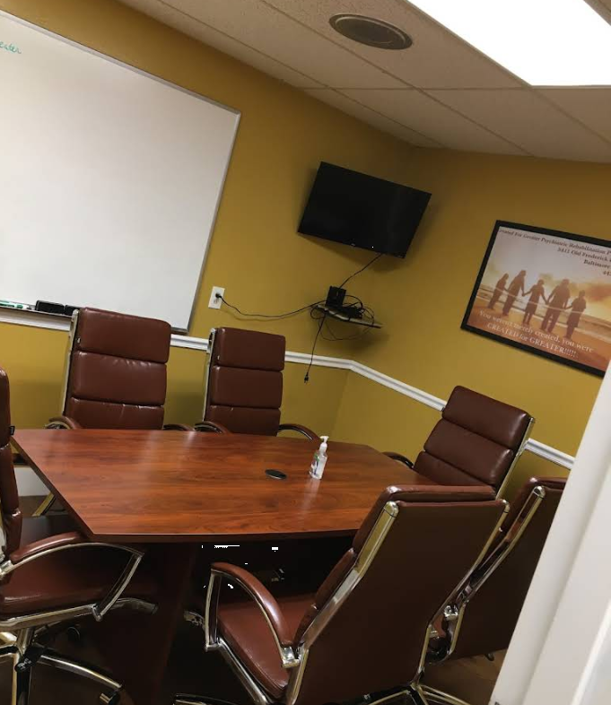 Conference room with large table and mounted TV