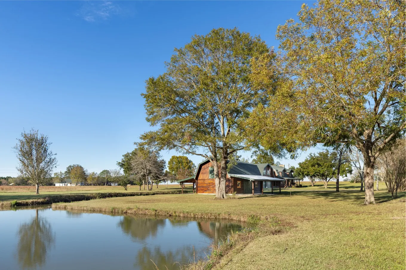 Log cabin beside a peaceful pond on spacious wooded grounds