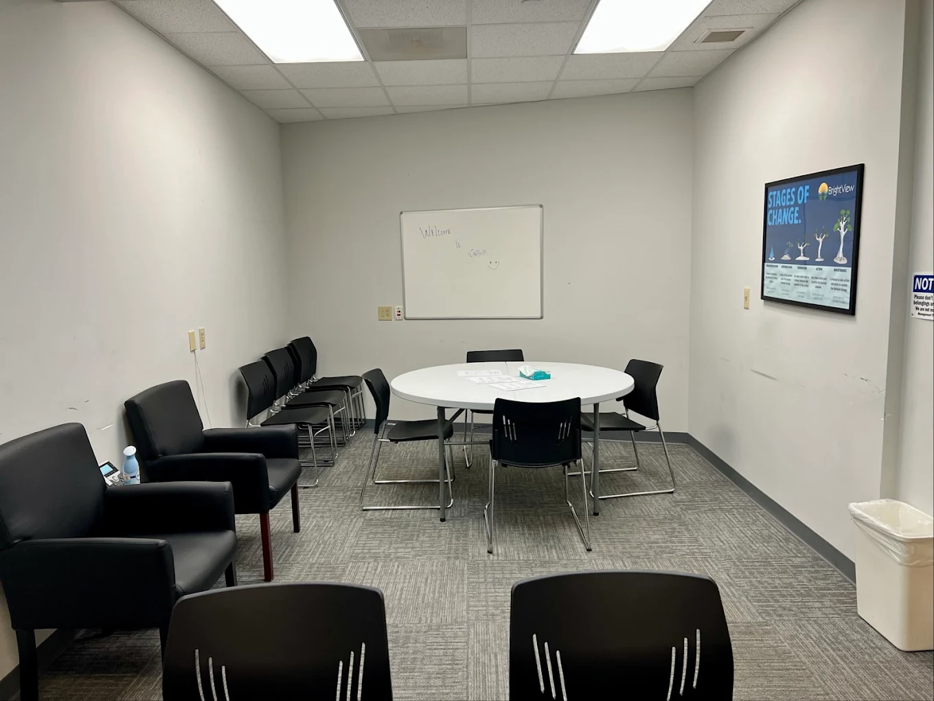 Meeting room with chairs and table under bright lighting
