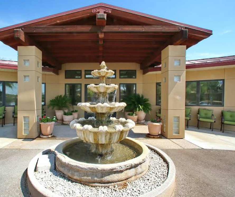 Tiered fountain at covered entrance with seating