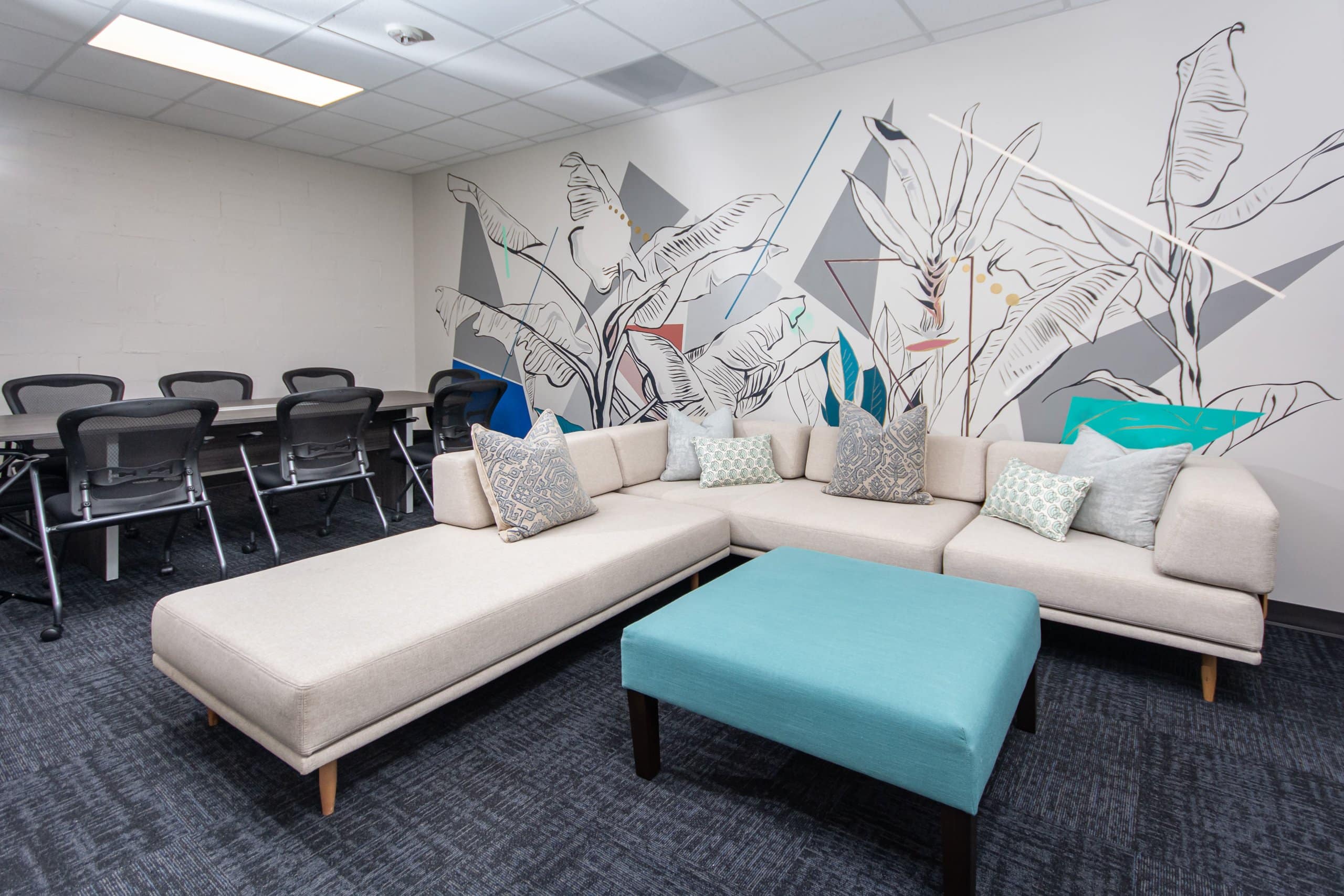 A modern meeting space with a white sectional sofa.