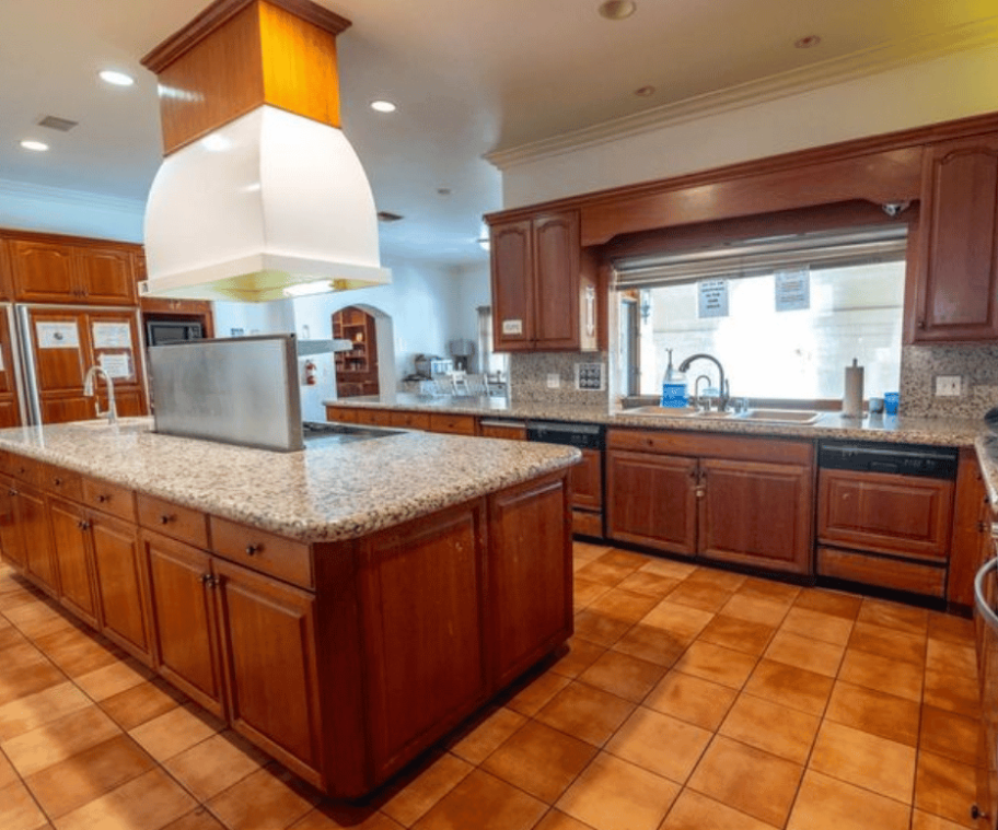 Large kitchen with island, cabinets, and modern appliances