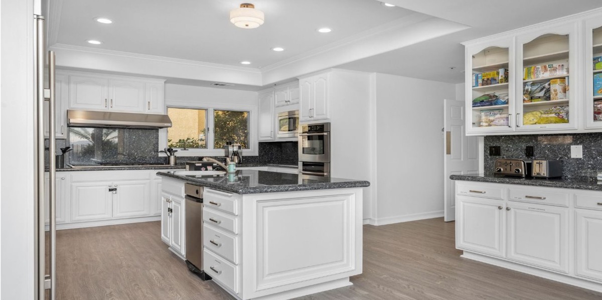 Modern white kitchen with island and stainless appliances
